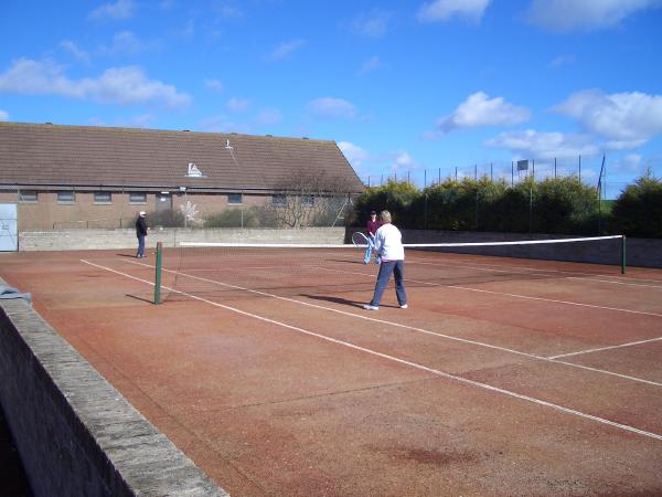 Back on court 1, David and Linda have found their partners . . . Alex (out of the picture) serving to David